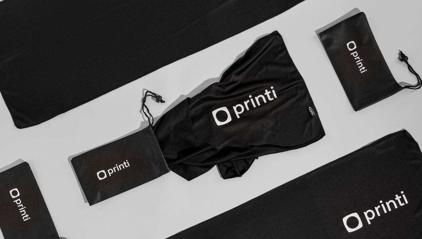 Toalha esportiva em PET com bolsa, ambas na cor preta com logo da Printi.