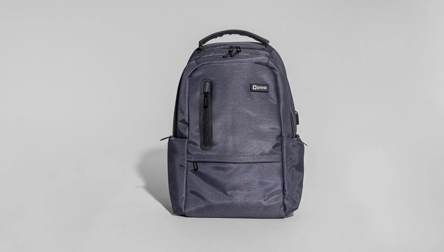 Mochila para notebook personalizada da Printi em tecido cinza escuro, com compartimentos frontais com zíper e design moderno