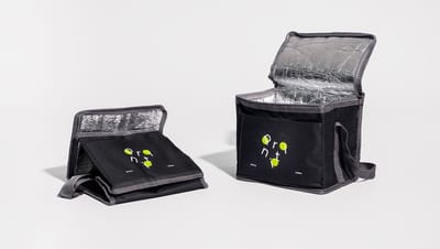 Bolsa térmica aberta perto de outra desmontadas, ambas na cor preta