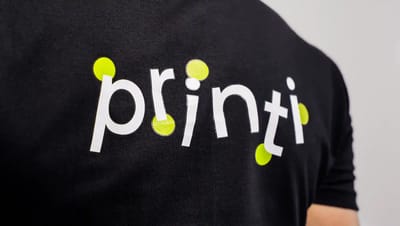 Camiseta personalizada preta com logotipo estampado no peito, ideal para uniformes e brindes corporativos.