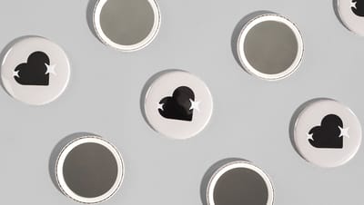 Botton espelho personalizado com desenho de coração na parte da frente.