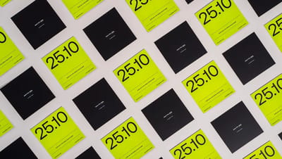Cartões “Save the Date” impressos em papel com design moderno nas cores preto e verde neon, organizados em padrão repetido sobre fundo neutro. Os cartões destacam a data “25.10” em tipografia grande e minimalista