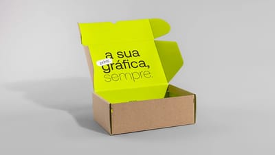 Visão lateral de caixa de papelão kraft para envio aberta com interior personalizado em verde neon, ideal para unboxing experience premium.