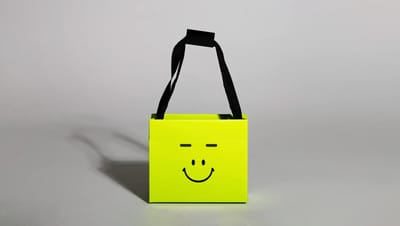 Visão frontal de sacola de papel teepee verde personalizada com a frase "A sua gráfica, sempre" e acabamento premium para marcas.