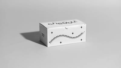 Embalagem personalizada para combos de comida em caixa branca com design minimalista e tipografia “chegou.” e “hmmmmmmm…”